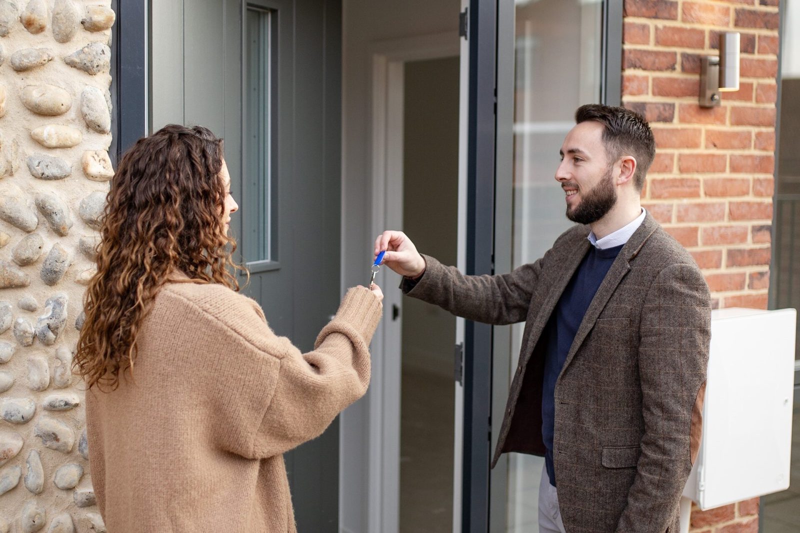 Keys handed over at the front door of a new home